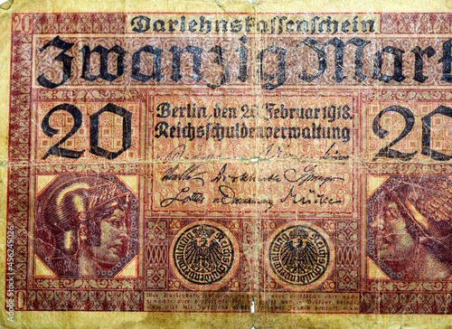 Large fragment of the obverse side of 20 twenty German marks banknote currency issued 1918 by Germany Reichsschuldenverwaltung in Berlin,   Note features Minerva and Mercury photo