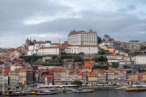 Porto, Portugal, October 31,2020. View on colorful old houses on hill in old part of city and embankment of Douro river in rainy day © barmalini