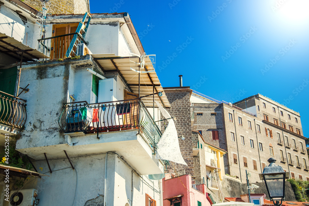 Typical house in italy. On the balcony the flag of italy and clothes to dry