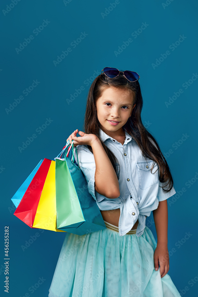 happy little caucasian child girl holds many shopping bags happy little caucasian child girl holds many shopping bags