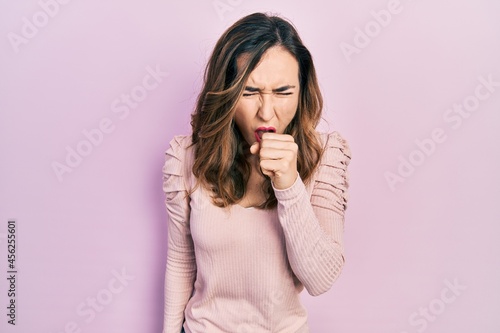 Young hispanic girl wearing casual clothes feeling unwell and coughing as symptom for cold or bronchitis. health care concept.