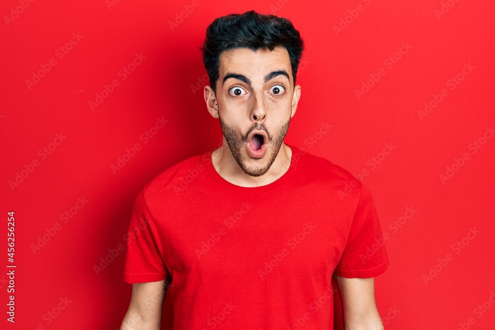 Young hispanic man wearing casual clothes scared and amazed with open mouth for surprise, disbelief face Young hispanic man wearing casual clothes scared and amazed with open mouth for surprise, disbelief face