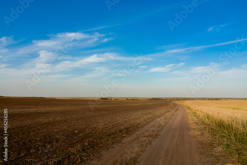 road in the field with clouds