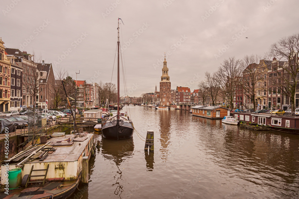 Houseboats and sailing boat on one of Amsterdarm's main canals
