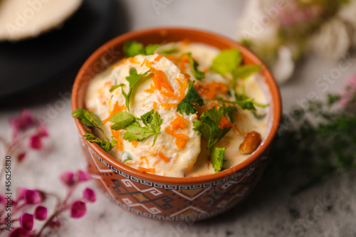 Dahi idly, curd idly , perugu idly indian style breakfast in a bowl closeup photo