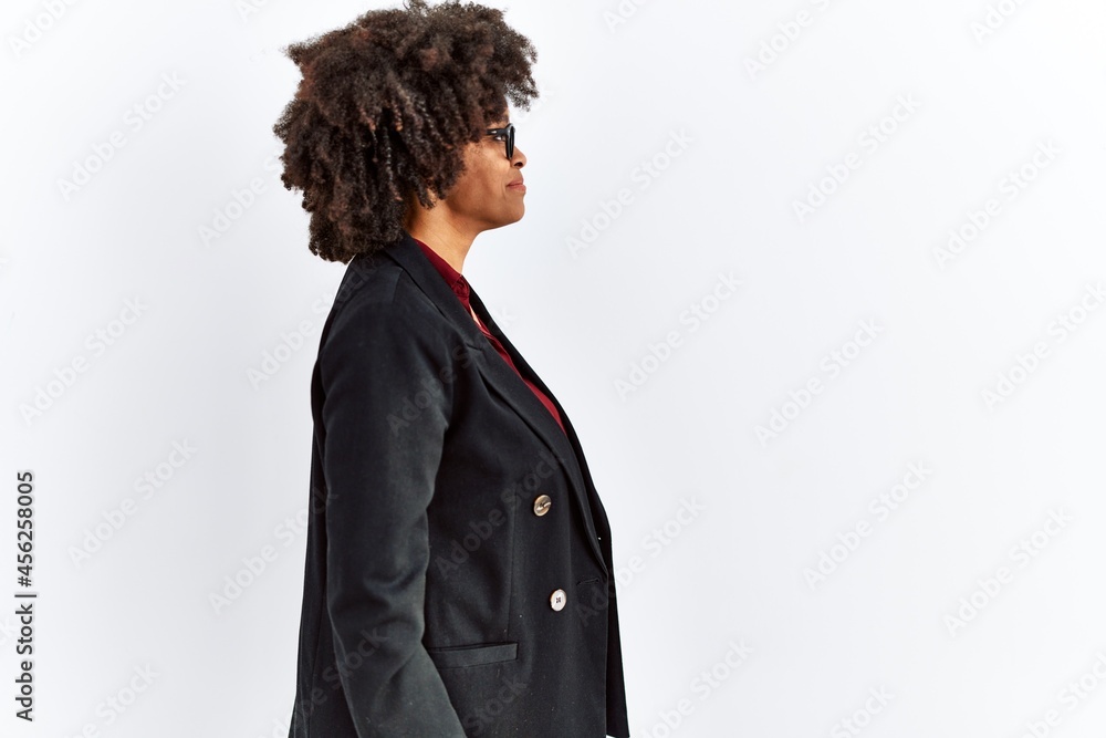 African american woman with afro hair wearing business jacket and glasses looking to side, relax profile pose with natural face and confident smile. African american woman with afro hair wearing business jacket and glasses looking to side, relax profile pose with natural face and confident smile.