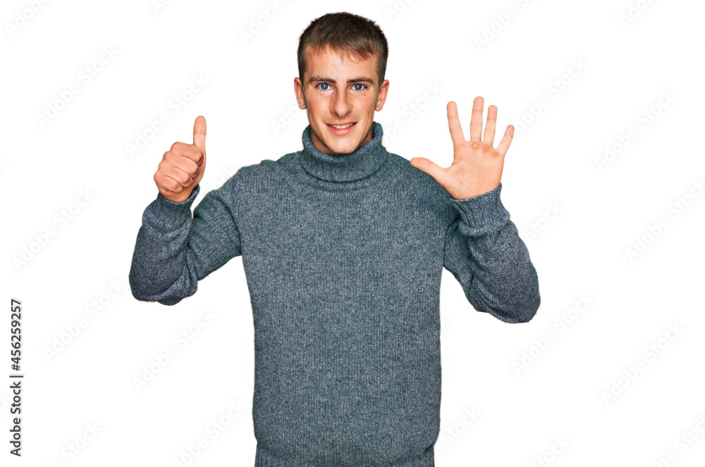 Fototapeta premium Young blond man wearing casual clothes showing and pointing up with fingers number six while smiling confident and happy.