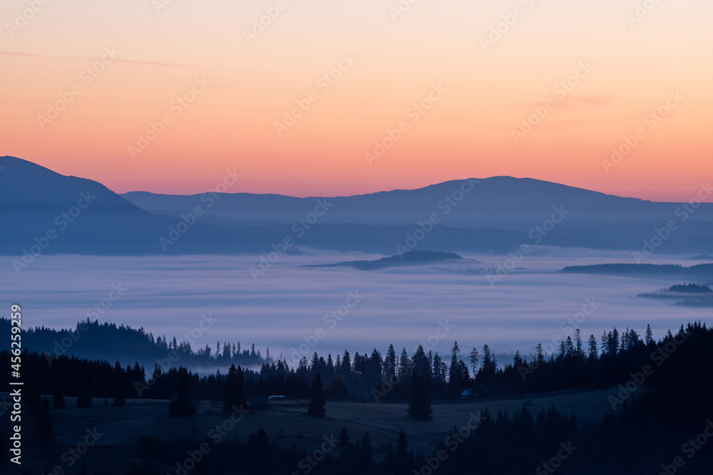 Fototapeta premium landscape with mountains and fog in the valleys in the morning