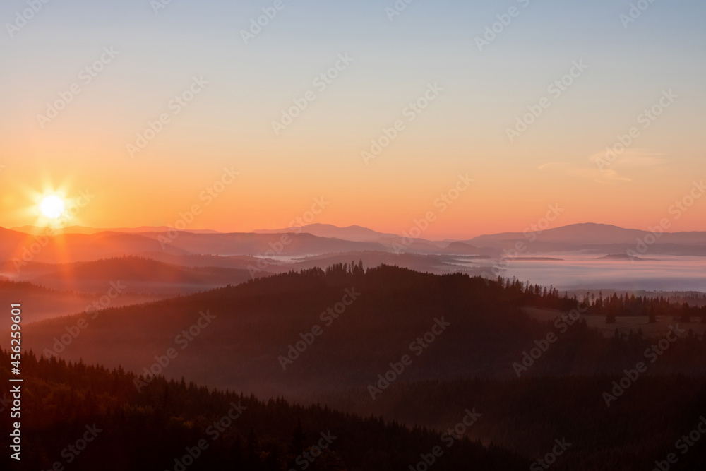 landscape with sunrise over the mountains and fog in the valleys landscape with sunrise over the mountains and fog in the valleys