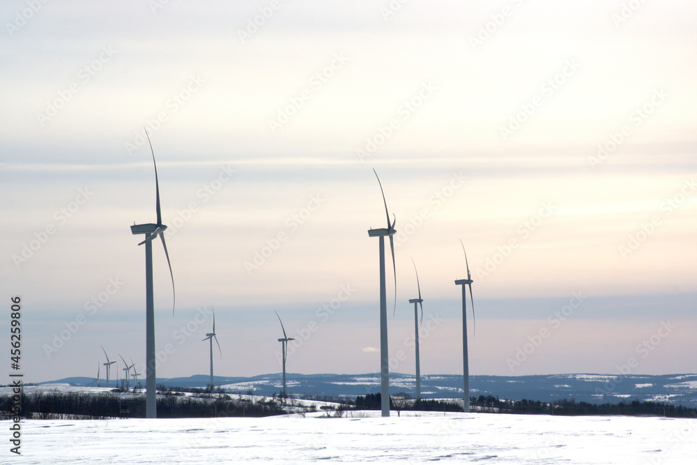windmill generators, snow landscape. Powerplant electric turbine. Clean energy and eco energy concept. 