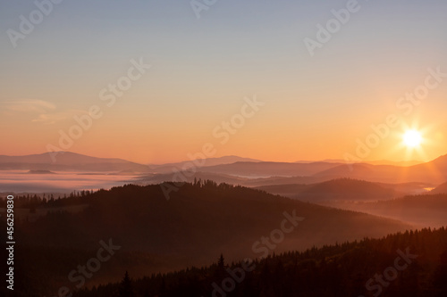 a beautiful landscape with hills and valleys at sunrise