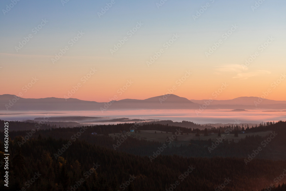 landscape with mountains and fog in the valleys in the morning