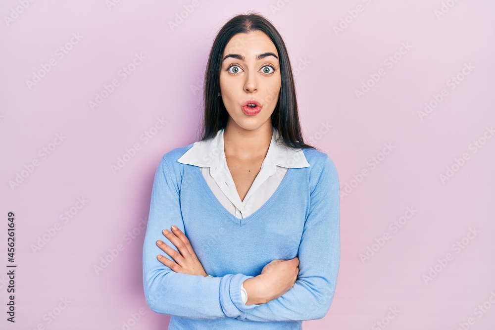 Beautiful woman with blue eyes standing over pink background afraid and shocked with surprise expression, fear and excited face. Beautiful woman with blue eyes standing over pink background afraid and shocked with surprise expression, fear and excited face.