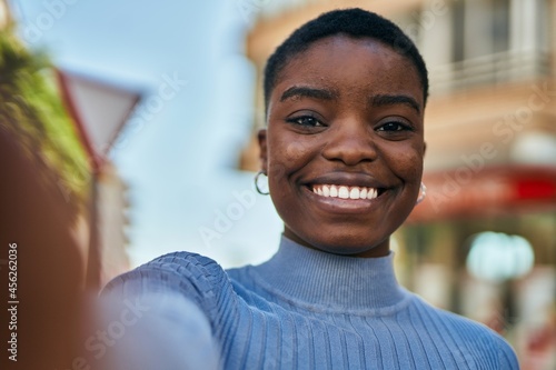 Young african american woman smiling happy making selfie by the camera at the city.