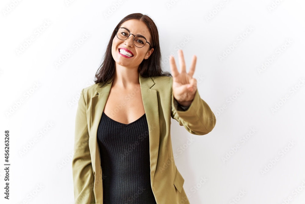 Young brunette woman standing over isolated background showing and pointing up with fingers number three while smiling confident and happy. Young brunette woman standing over isolated background showing and pointing up with fingers number three while smiling confident and happy.