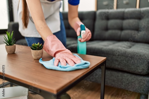 Konstfotografi Woman cleaning table using rag and diffuser at home.