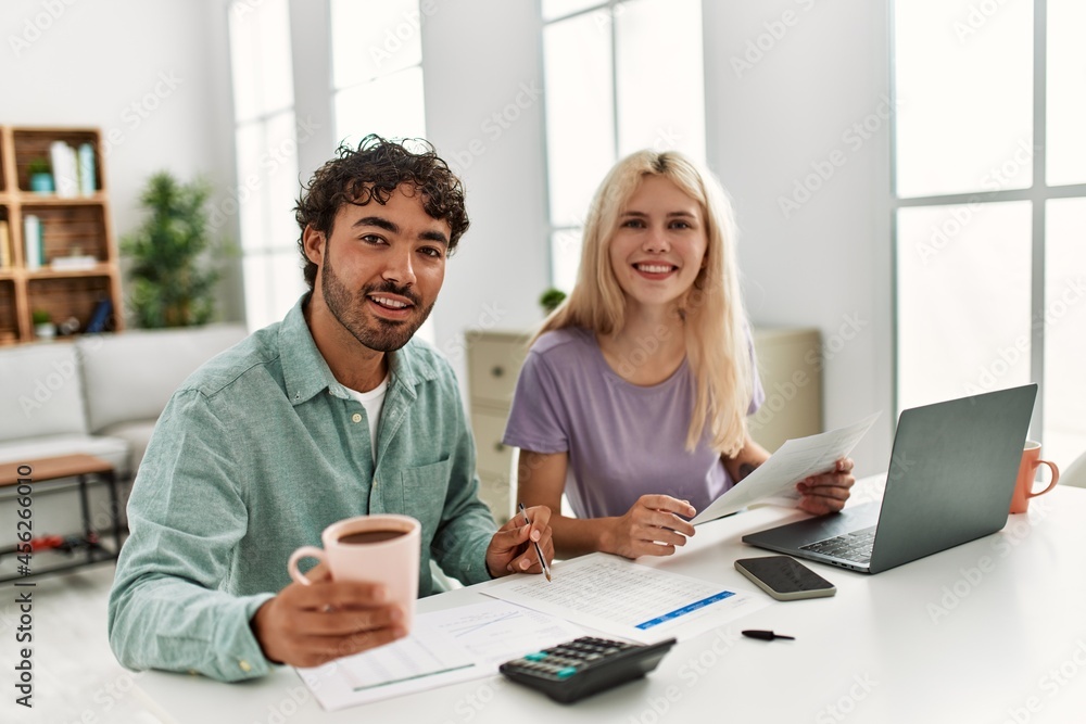 Young couple controlling family economy at home. Young couple controlling family economy at home.