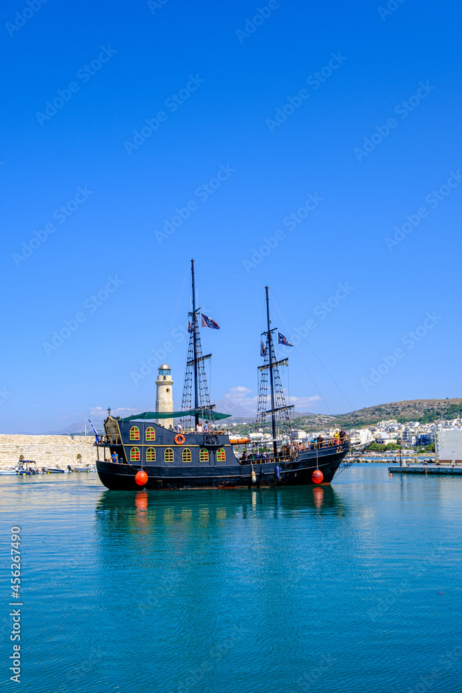Fototapeta premium Black ship on the Greece sea. Turistic ship in Greece