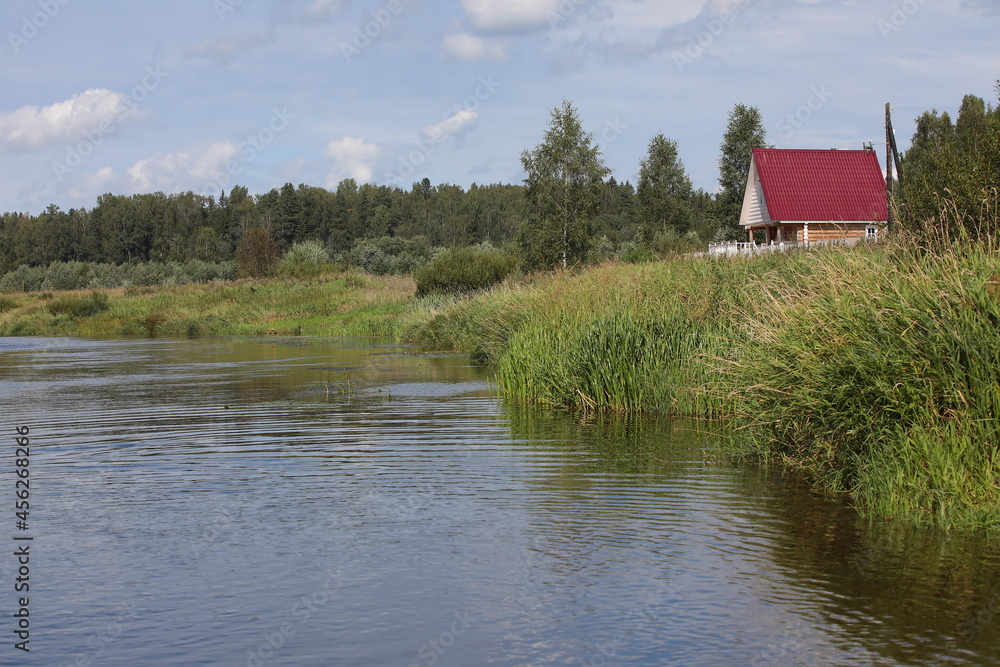House on the river modern wooden structure with an attic with panorama from the windows.Rent a retreat for a family with a backyard forest.The concept of a secluded holiday in an ecological location House on the river modern wooden structure with an attic with panorama from the windows.Rent a retreat for a family with a backyard forest.The concept of a secluded holiday in an ecological location