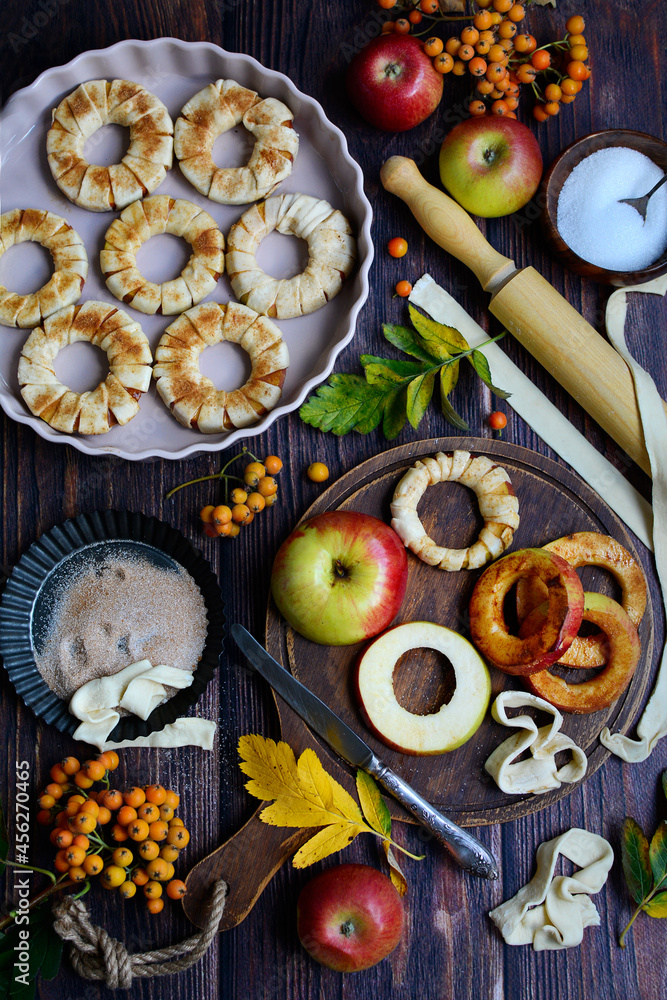 Vertical composition. Apples, dough, cinnamon, sugar are ingredients for baking. View from above