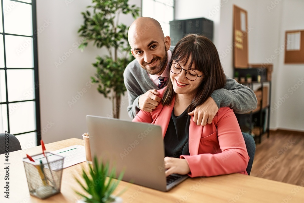 Two hispanic business workers smiling happy working at the office. Two hispanic business workers smiling happy working at the office.