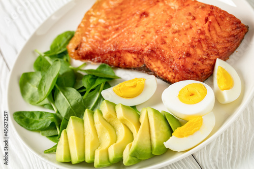 baked salmon fillet with eggs , spinach, avocado
