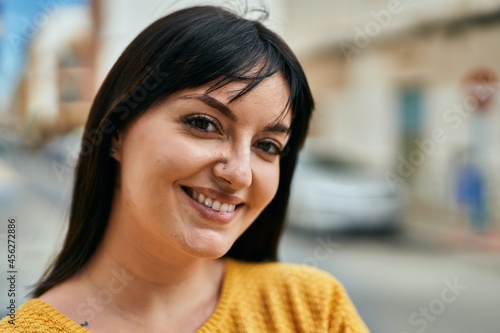 Young brunette woman smiling happy at the city © Krakenimages.com