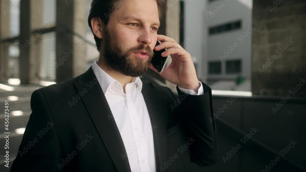 Successful young handsome man having phone talk at the office stairs. Businessman. High quality 4k footage