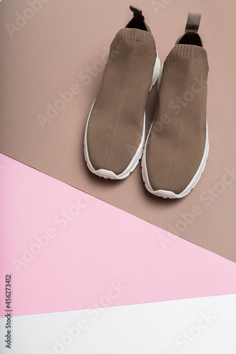 modern beige sneakers with white soles on multicolour background - Image