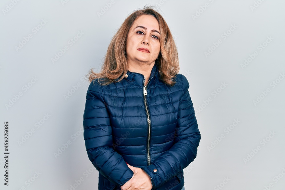 Middle age caucasian woman wearing casual clothes relaxed with serious expression on face. simple and natural looking at the camera. Middle age caucasian woman wearing casual clothes relaxed with serious expression on face. simple and natural looking at the camera.