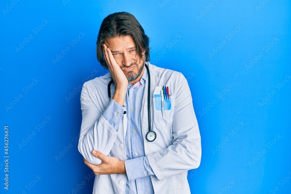 Middle age handsome man wearing doctor uniform and stethoscope thinking looking tired and bored with depression problems with crossed arms. Middle age handsome man wearing doctor uniform and stethoscope thinking looking tired and bored with depression problems with crossed arms.