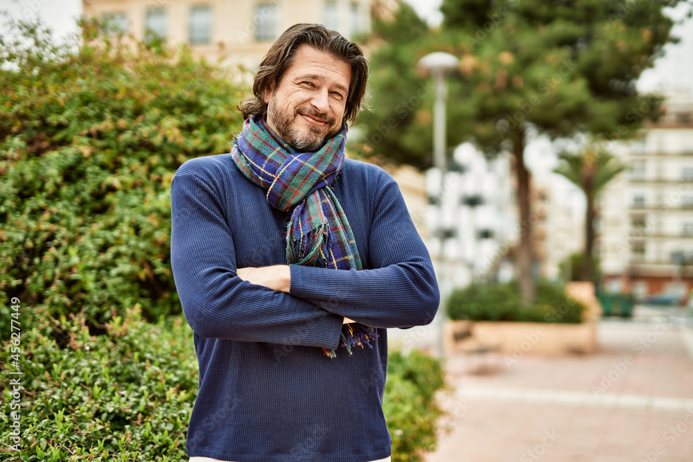 Middle age handsome man smiling with crossed arms outdoors at the park Middle age handsome man smiling with crossed arms outdoors at the park