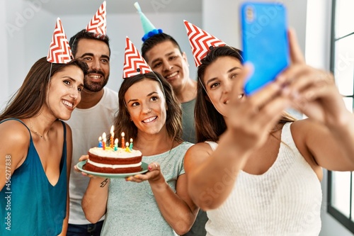 Canvas Print Young hispanic woman smiling happy and holding birthday cake