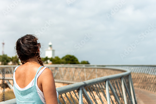 Girl with braids looking at the lighthouse.