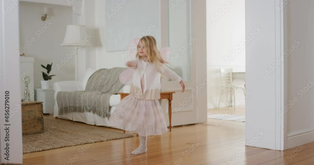 happy little girl dancing playfully pretending to be ballerina funny child having fun playing dress up wearing fairy wings ballet costume at home 4k happy little girl dancing playfully pretending to be ballerina funny child having fun playing dress up wearing fairy wings ballet costume at home 4k