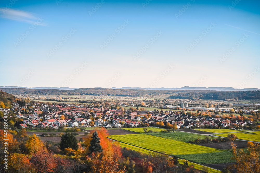 Scenic autumnal view of the Neckar valley and the village of Hirschau, Germany during dawn.