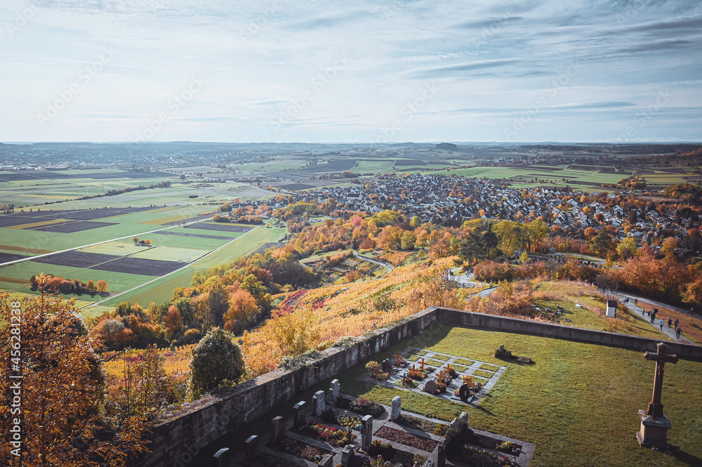 Scenic aerial view over the cemetery of St. Remigius chapel near Wurmlingen, Germany and the autumnal countryside in the background.