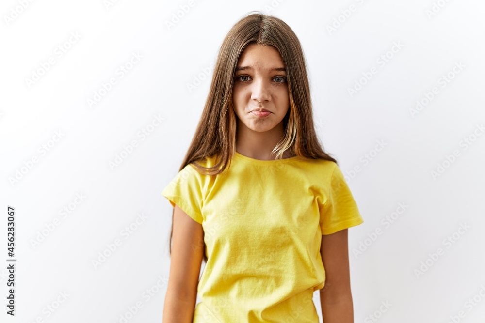 Young brunette teenager standing together over isolated background depressed and worry for distress, crying angry and afraid. sad expression.