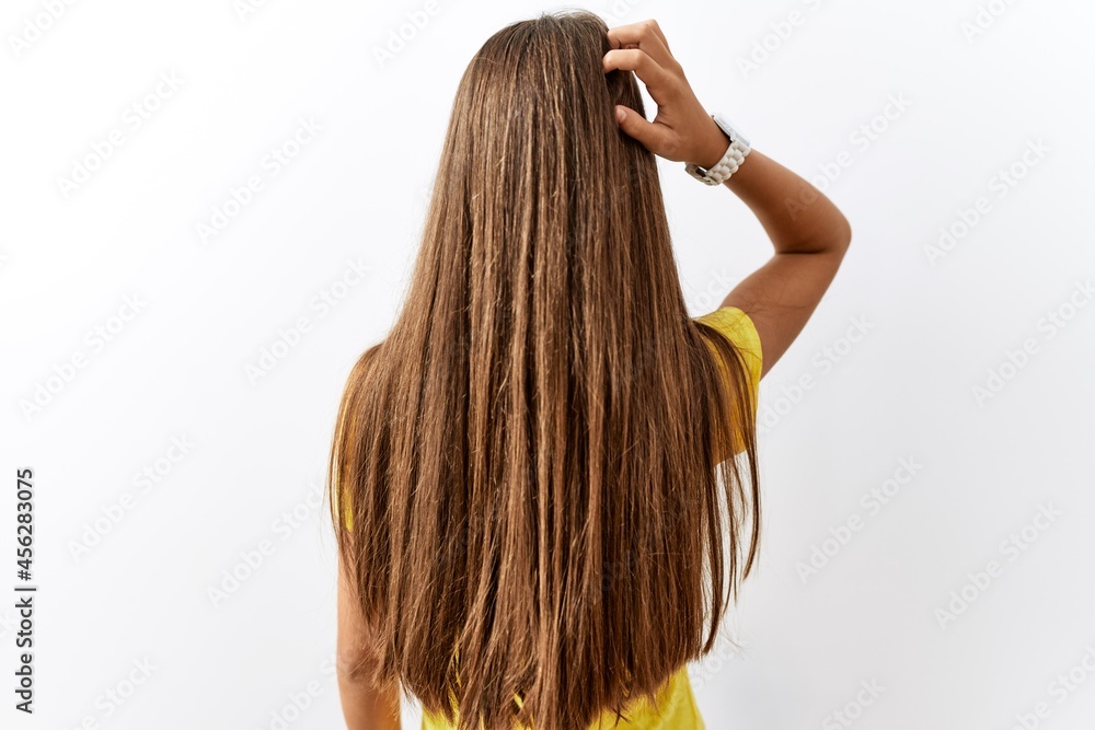 Young brunette teenager standing together over isolated background backwards thinking about doubt with hand on head Young brunette teenager standing together over isolated background backwards thinking about doubt with hand on head