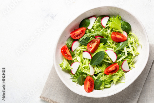 Bowl with vegetarian fresh salad. Healthy food, diet lunch. Top view on a white background. © Roman Rvachov