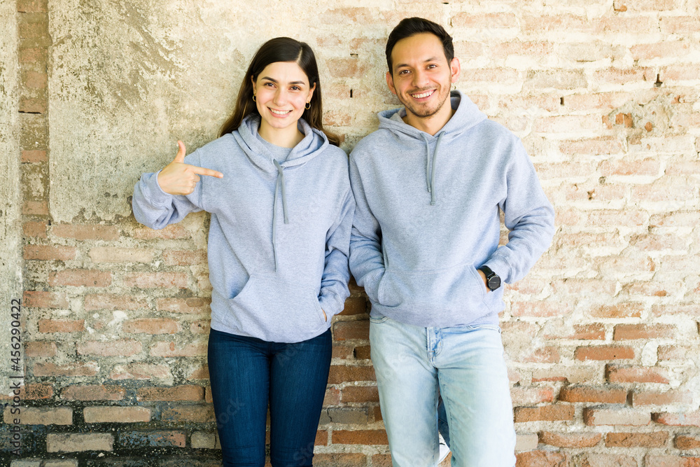 Young woman and man with custom print hoodies