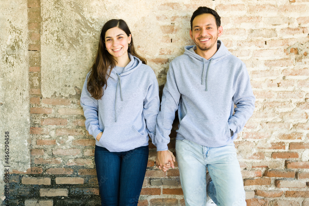 Attractive couple with matching hoodies Attractive couple with matching hoodies