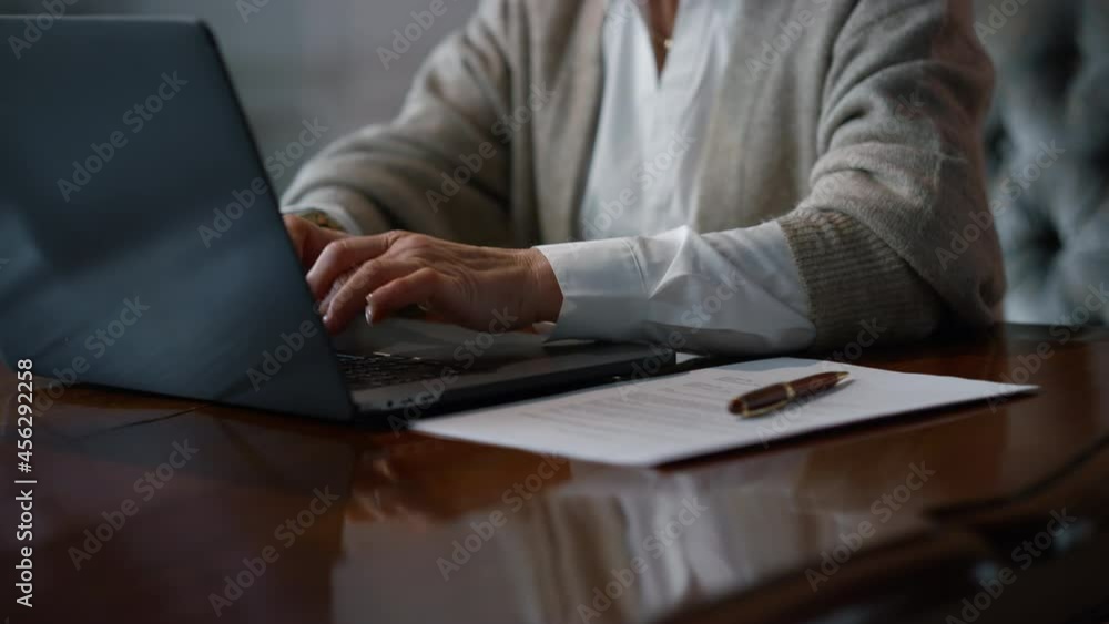 Unknown senior woman hands typing laptop luxury interior. Lady using computer. Unknown senior woman hands typing laptop luxury interior. Lady using computer.