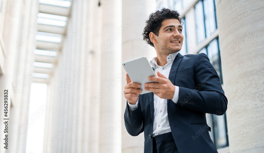 An economist goes to work in a business suit. The lawyer responds to clients ' email messages. The financier writes a message to a colleague on a mobile phone. A bank employee near the office.