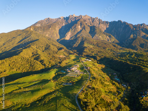 Beautiful panorama view of rocky mountain range Mount Kinabalu with tropical landscape during morning. Mount Kinabalu view in Kundasang Sabah Malaysia. photo