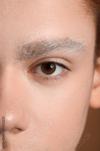 Teenage boy with dyed eyebr...