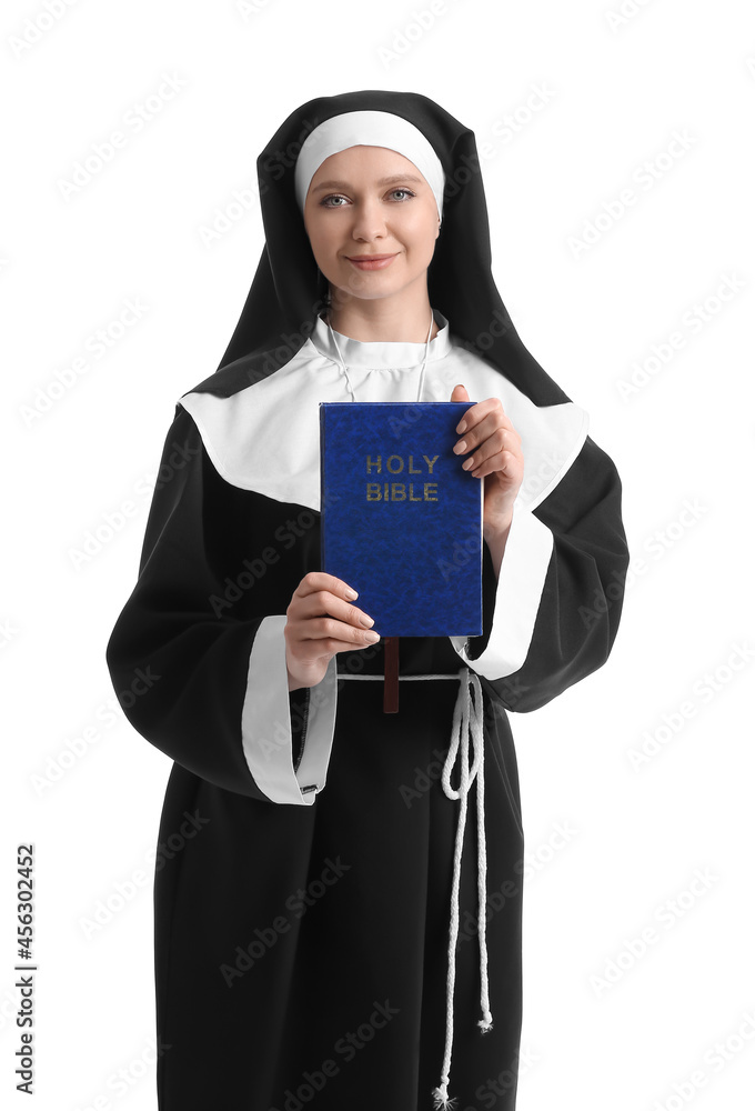 Young nun with Bible on white background Young nun with Bible on white background