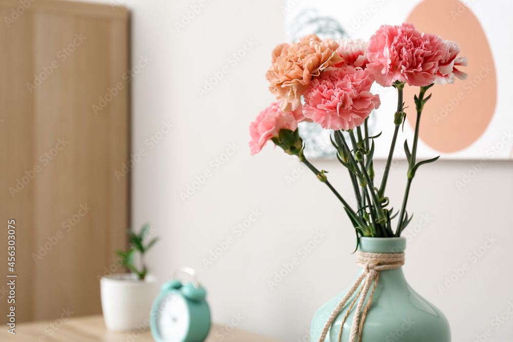 Vase with beautiful carnations in room Vase with beautiful carnations in room