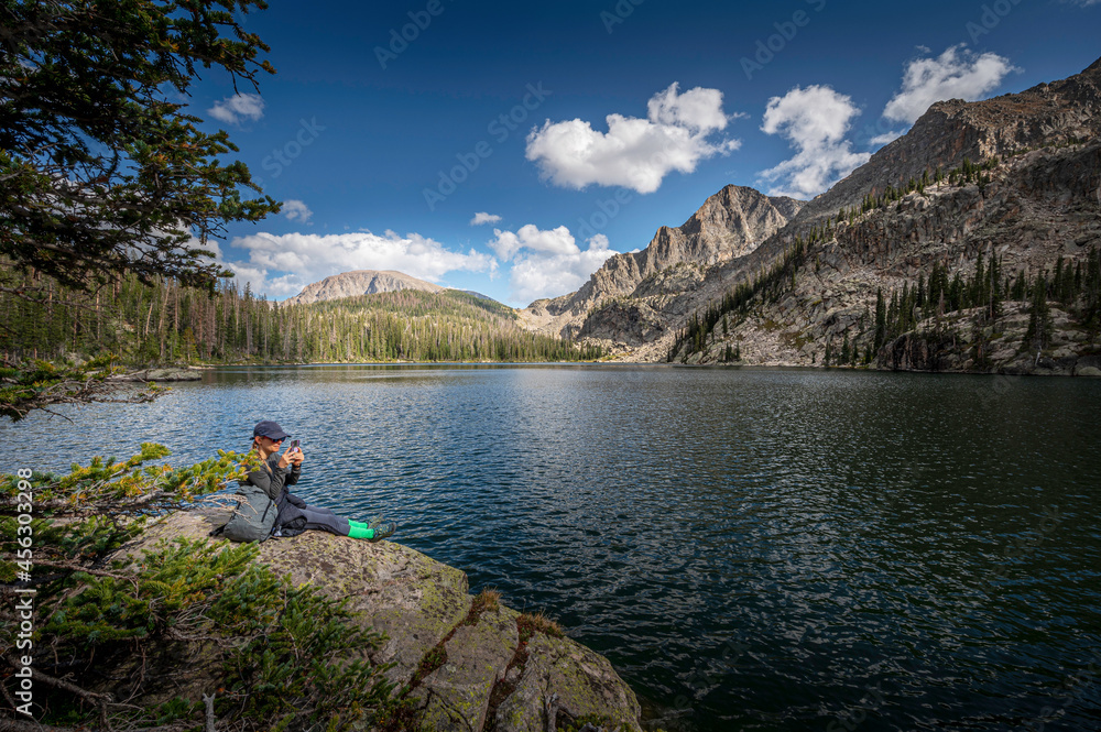 Hiker resting on a rock at Lake Nanita
