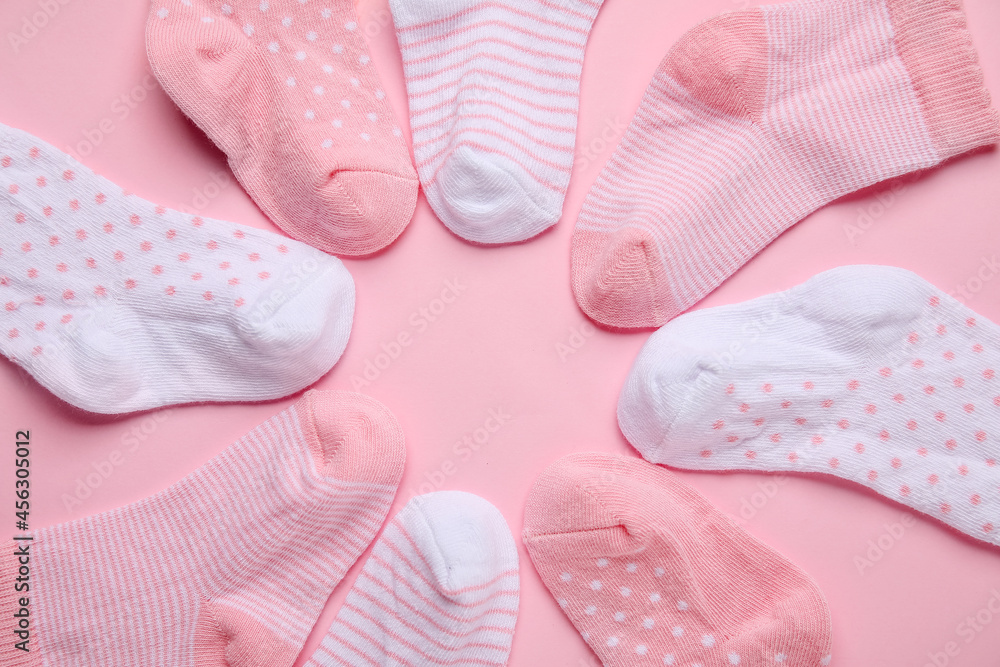 Frame made of different baby socks on color background, closeup Frame made of different baby socks on color background, closeup